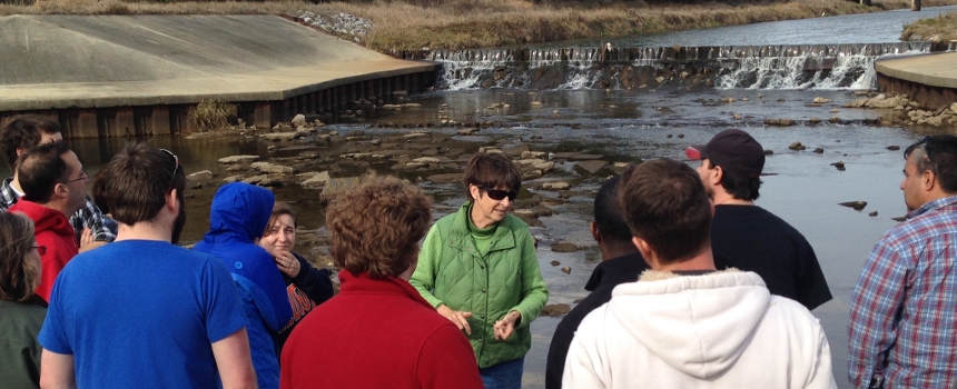 class on a field trip at a dam