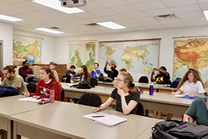 Students sitting at tables in class.