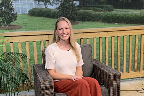 Dr. Meghan Hermance sitting on a bench.