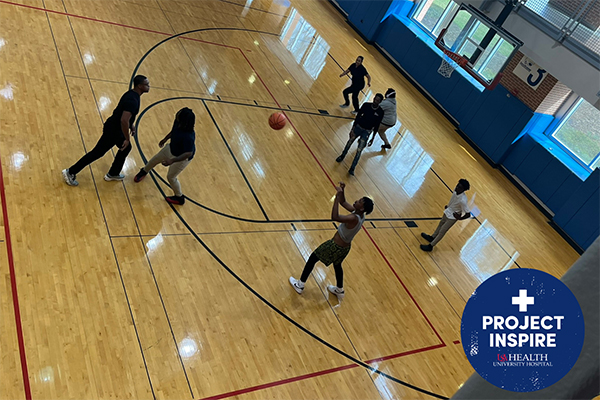 Participants in Project Inspire play basketball.