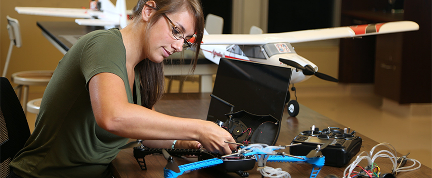 Female student working on drone