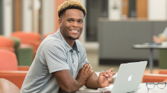 Student sitting at computer facing front