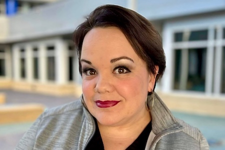 photo of Dr. Rebecca Thomas standing in front of a building