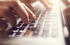 Hands typing on a keyboard