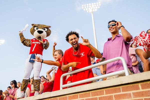 Southpaw and students cheering at a game.