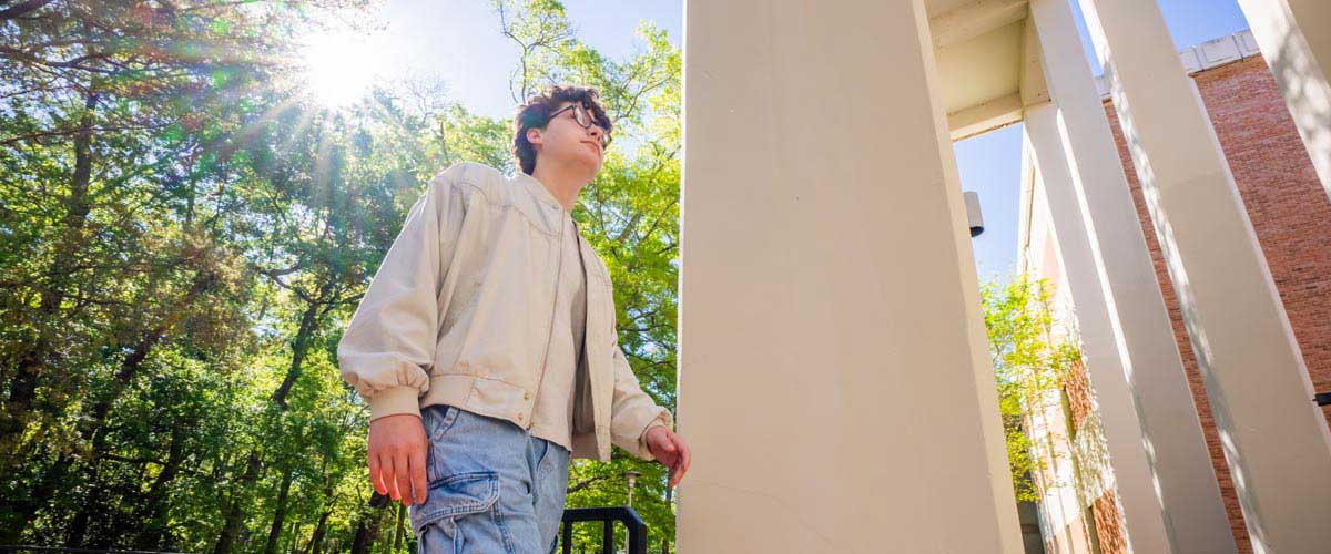 South student walking outside of the Humanities building.